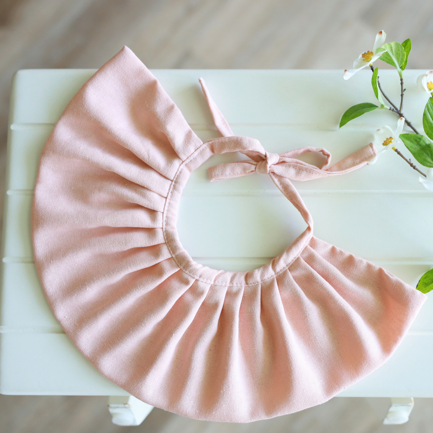 Close-up of cute pink dog bib to keep fur dry from food and water